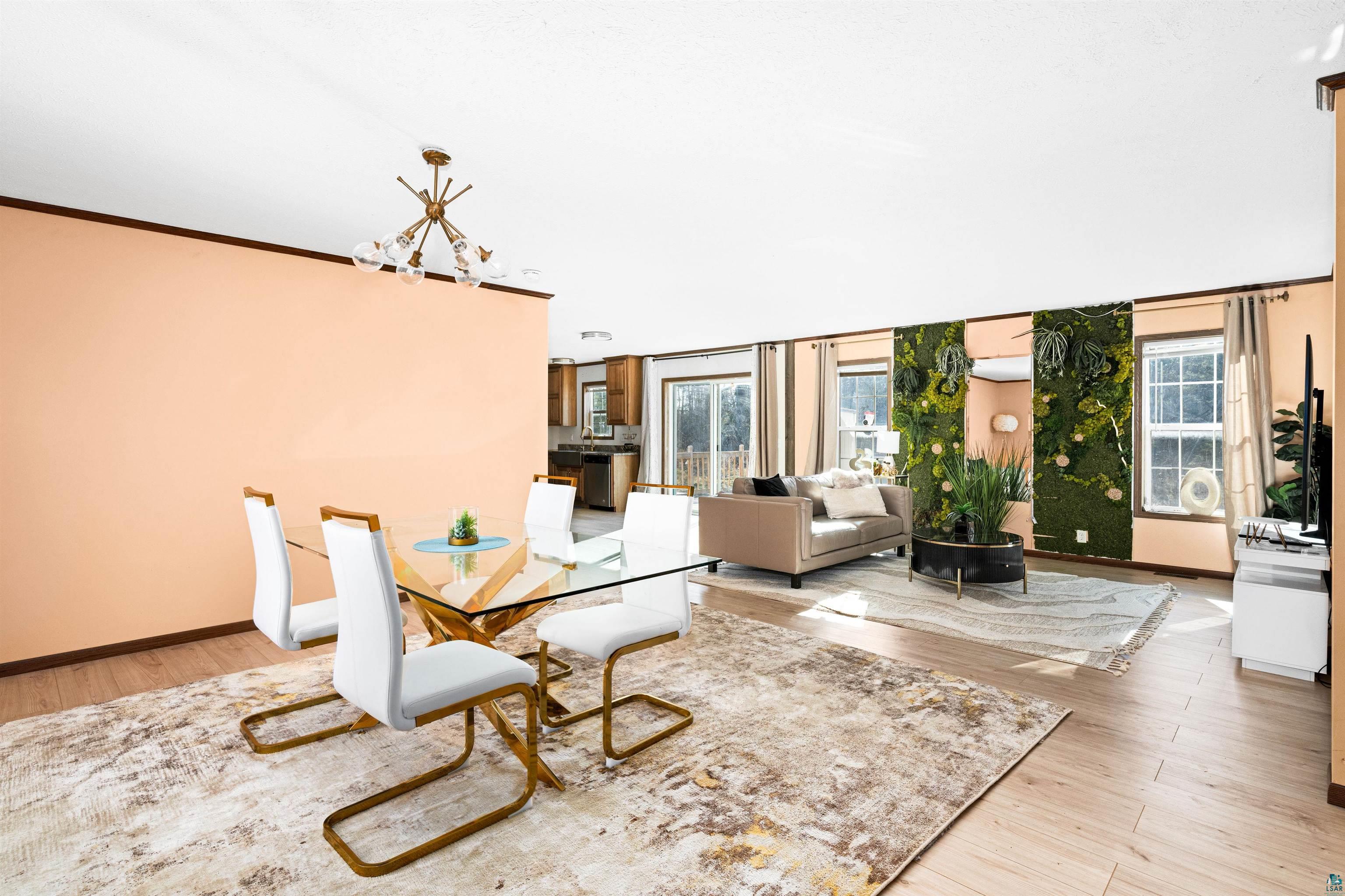5562 Lavaque Road Duluth, MN 55803 - Photo 9 of 28 Unfurnished dining area featuring a wealth of natural light, ornamental molding, a chandelier, and light hardwood / wood-style floors