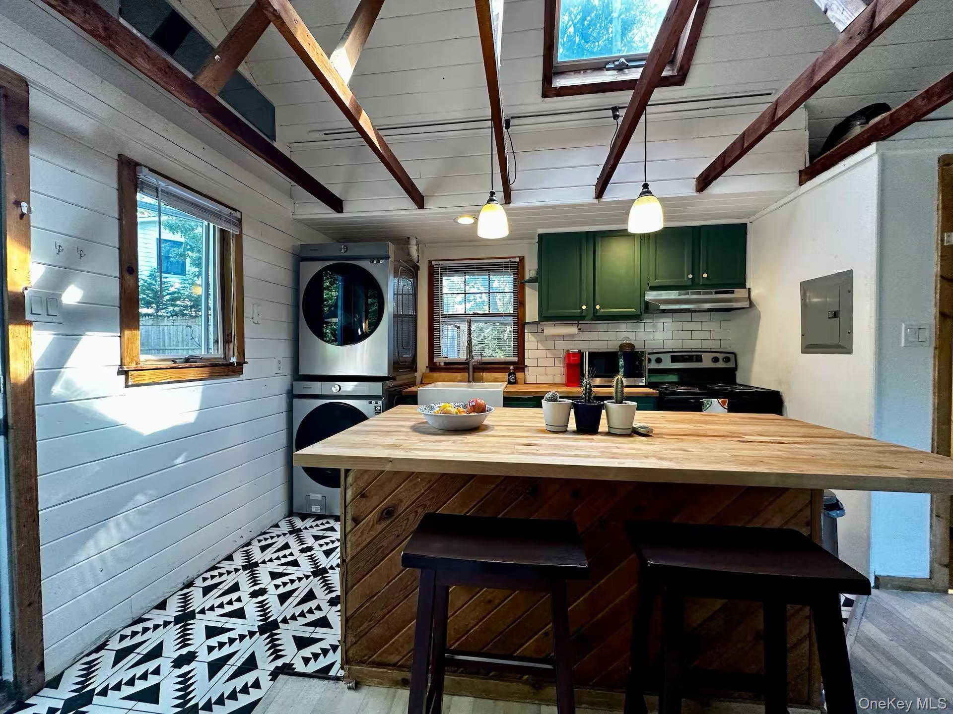 332 Canoe Place Road Southampton, NY 11968 - Photo 1 of 19 a kitchen with a table and chairs in it