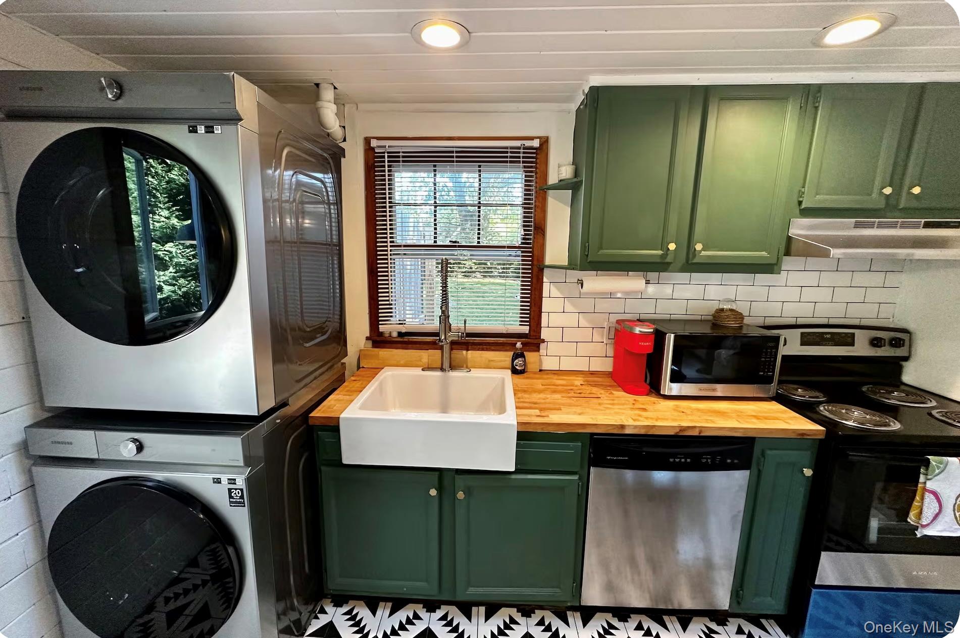 332 Canoe Place Road Southampton, NY 11968 - Photo 2 of 19 a bathroom with a sink a washer and dryer