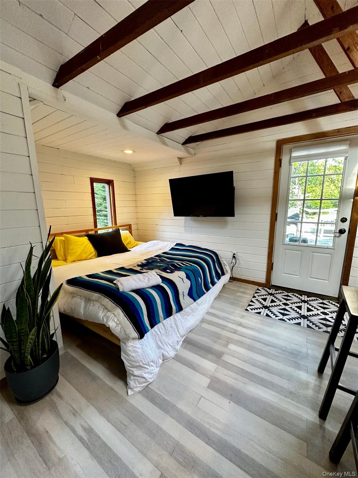 332 Canoe Place Road Southampton, NY 11968 - Photo 6 of 19 a bedroom with double bed and a window