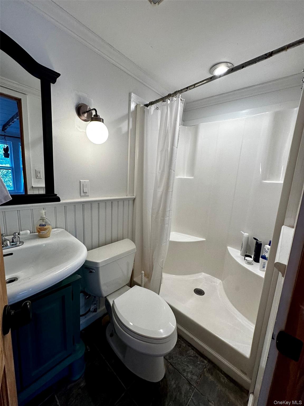 332 Canoe Place Road Southampton, NY 11968 - Photo 7 of 19 a bathroom with a sink toilet a mirror and shower