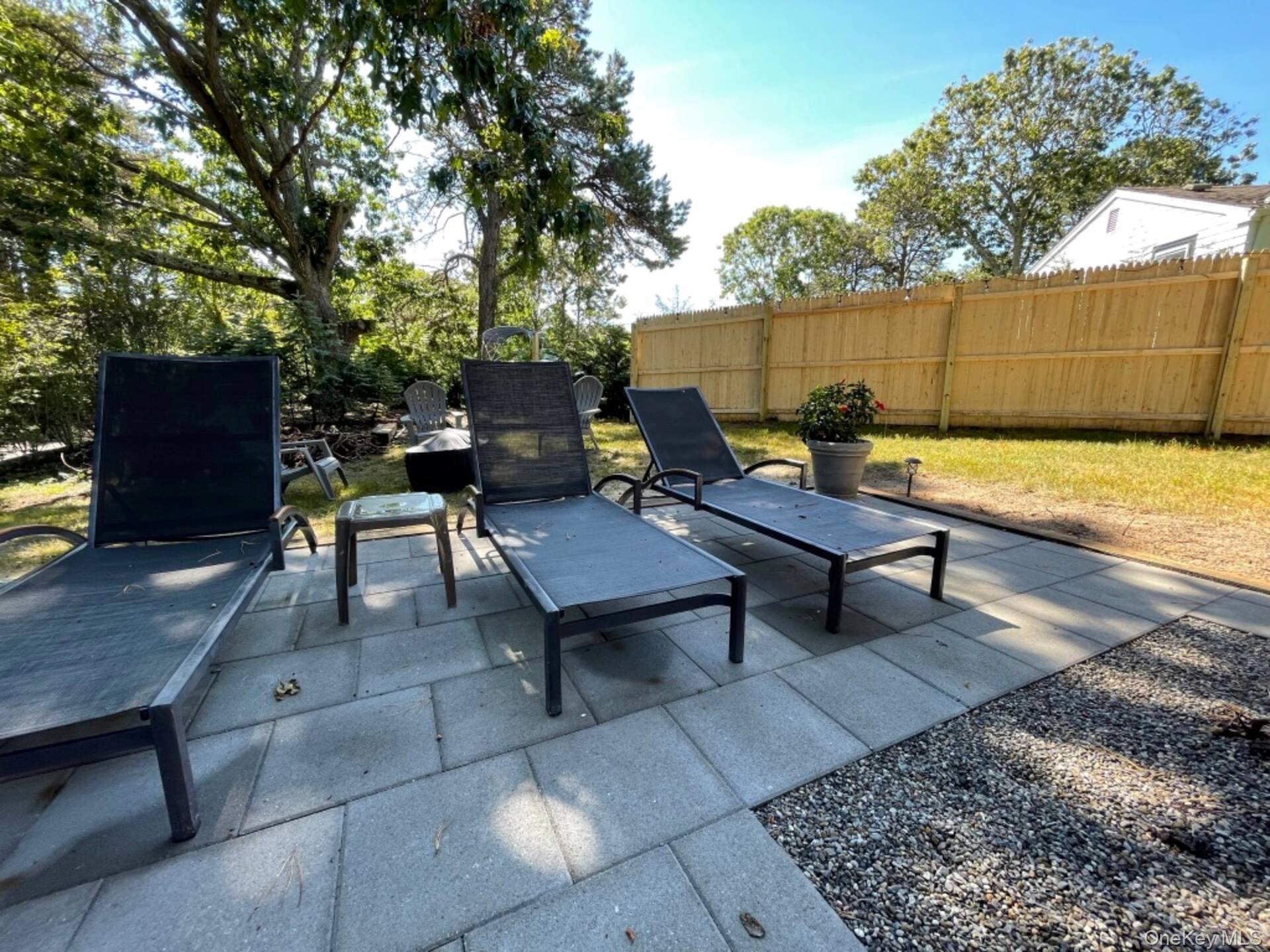 332 Canoe Place Road Southampton, NY 11968 - Photo 10 of 19 a view of a backyard with sitting area