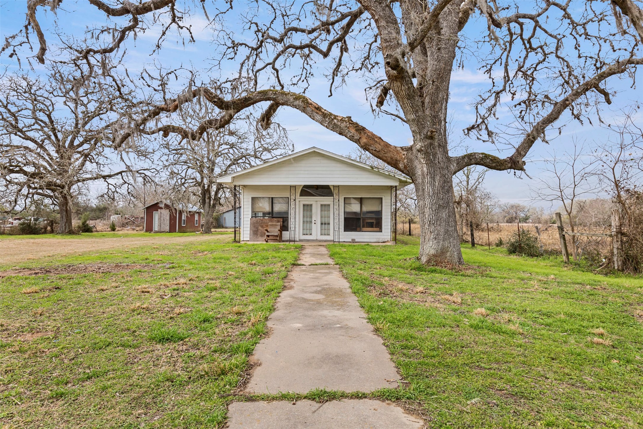 22279 Chapman Road Hempstead, TX 77445 - Photo 25 of 28 Guest house located behind the main house with a concrete pathway connecting them.