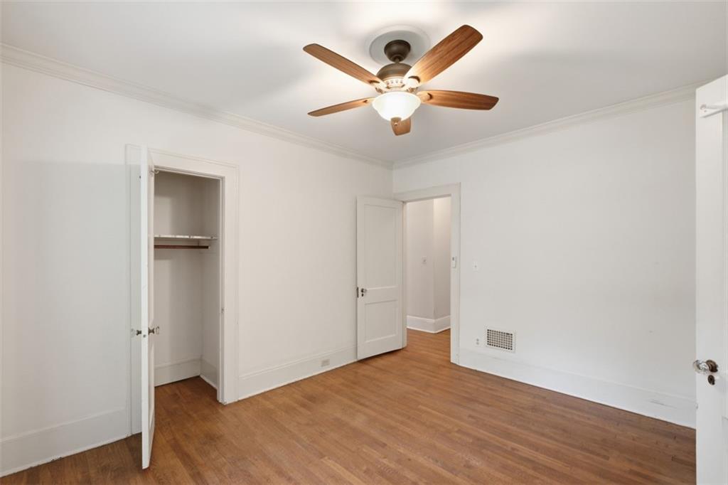 1424 Emory Road Northeast Atlanta, GA 30306 - Photo 19 of 36 an empty room with wooden floor and a ceiling fan