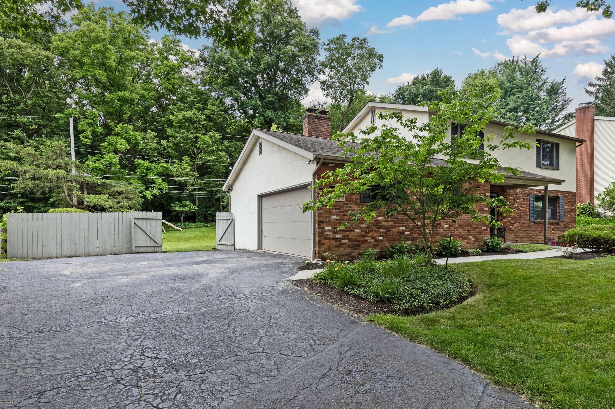 999 Birchmont Road Columbus, OH 43220 - Photo 41 of 53 Side load garage and nice sized driveway with ability for turning around.