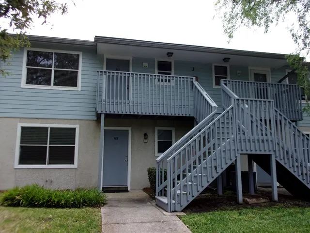 a view of house with front door and deck