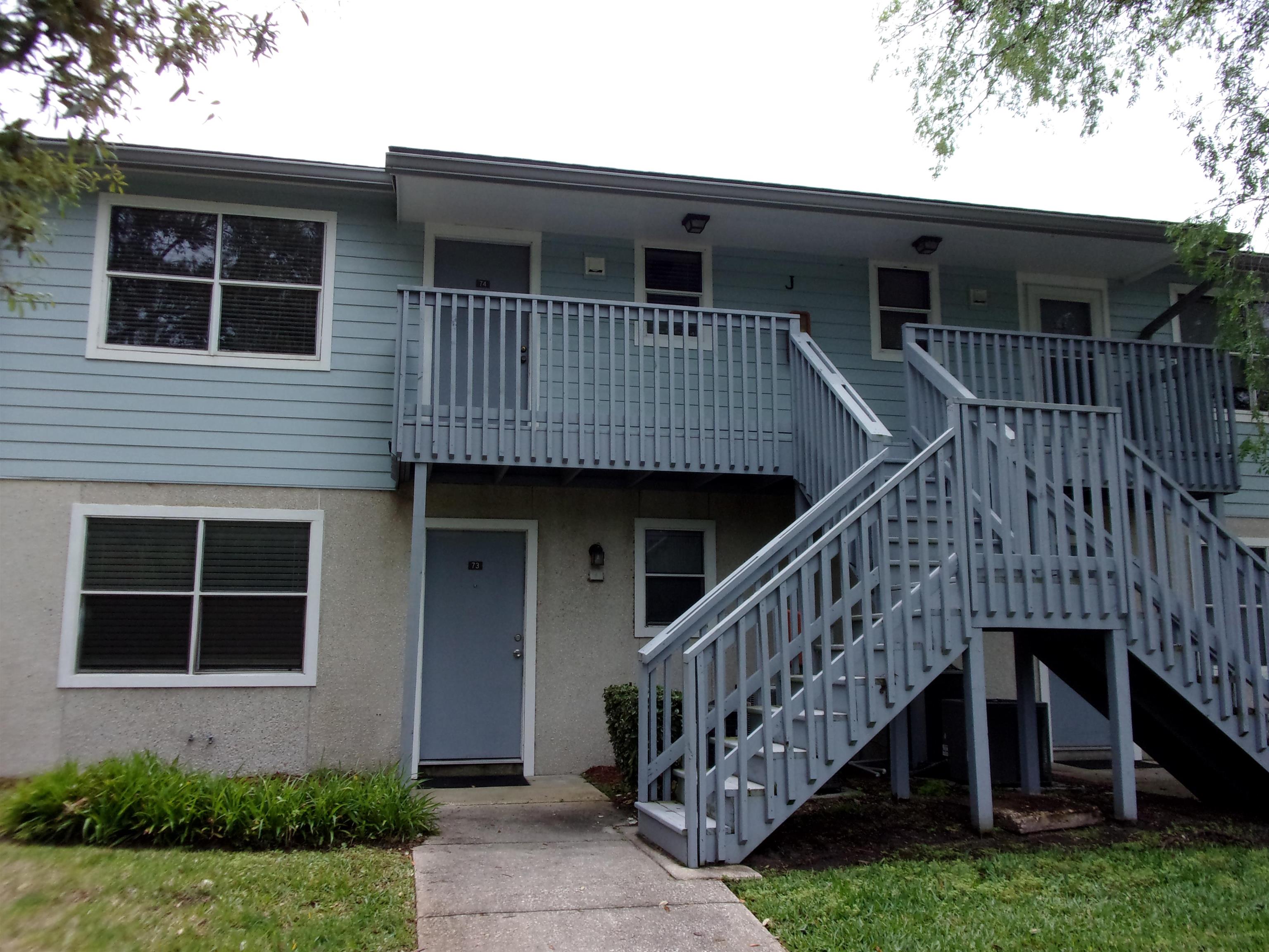 a view of house with front door and deck