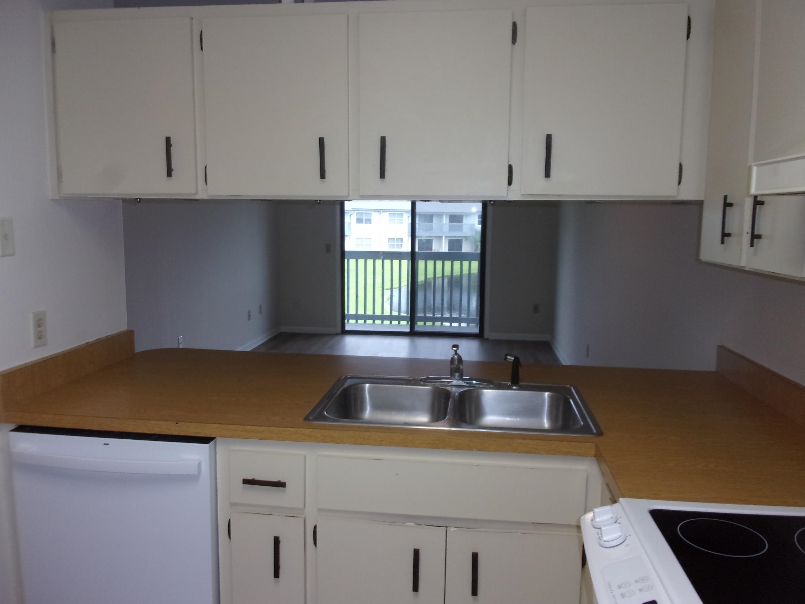 700 West Pope Road St. Augustine, FL 32080 - Photo 11 of 32 a kitchen with a sink and cabinets