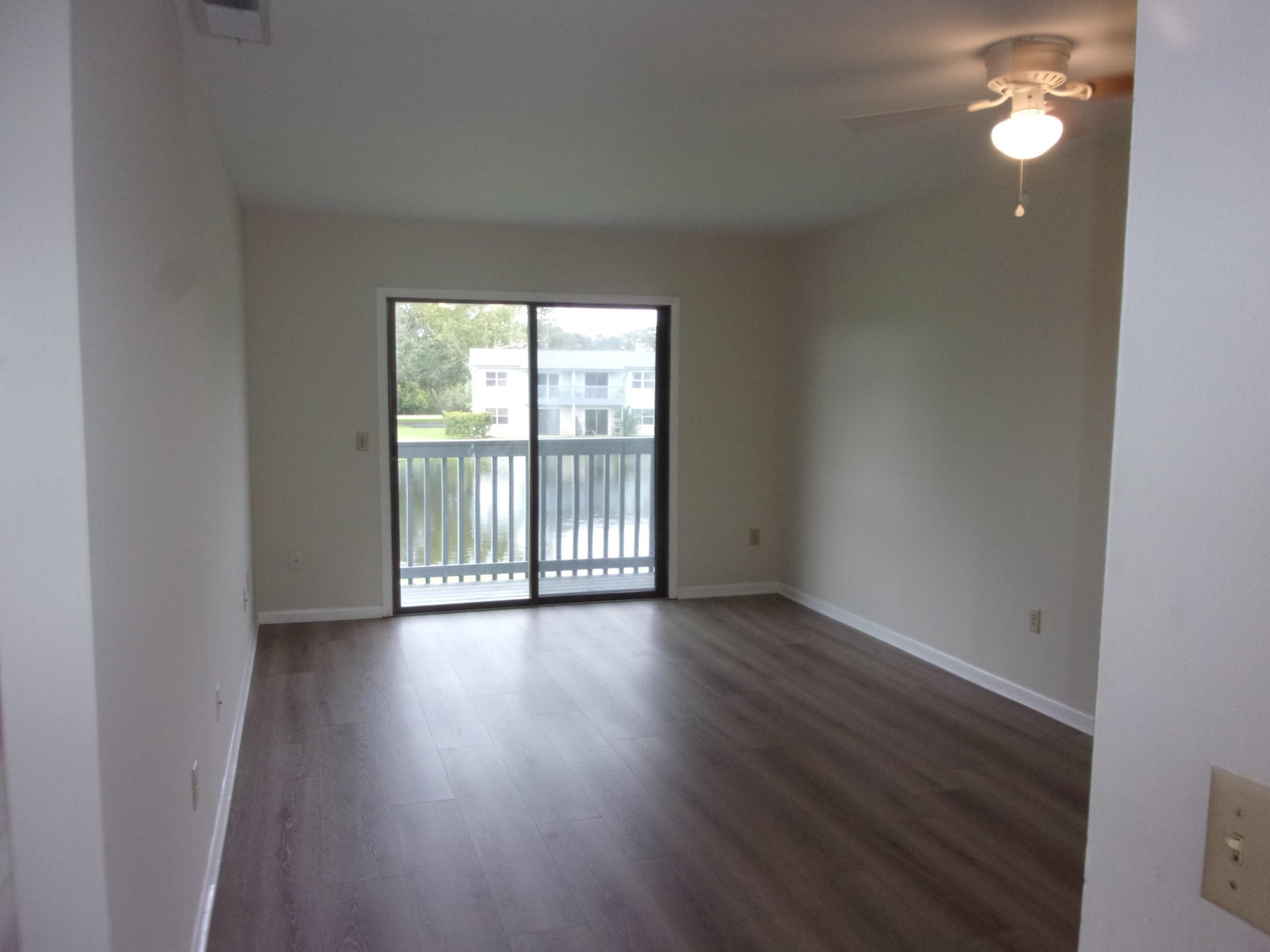 700 West Pope Road St. Augustine, FL 32080 - Photo 13 of 32 an empty room with wooden floor and windows