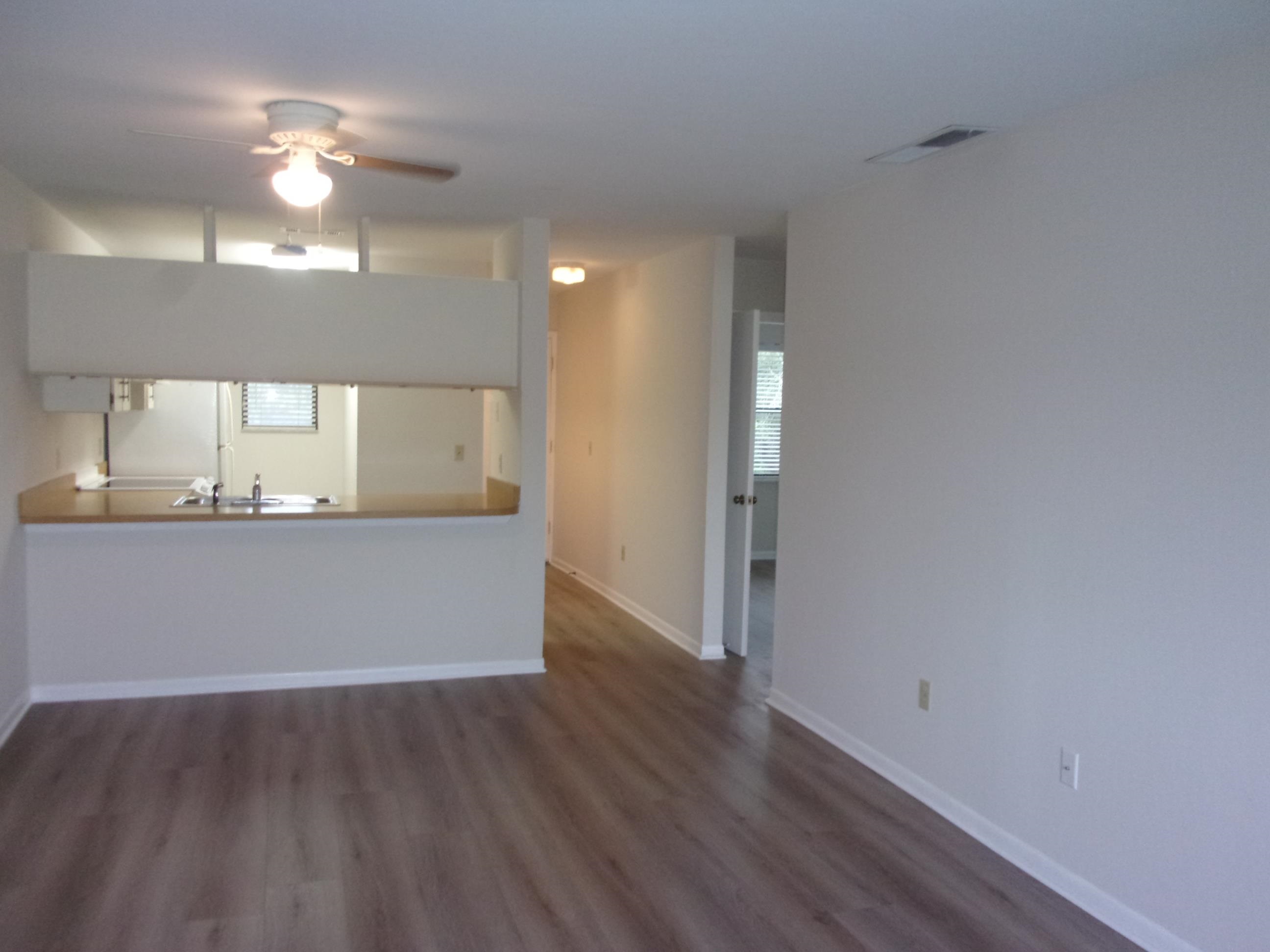 700 West Pope Road St. Augustine, FL 32080 - Photo 15 of 32 a view of an empty room with wooden floor and a window