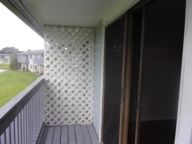 a view of balcony with wooden floor