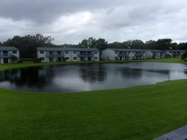 a view of a lake with houses in the back