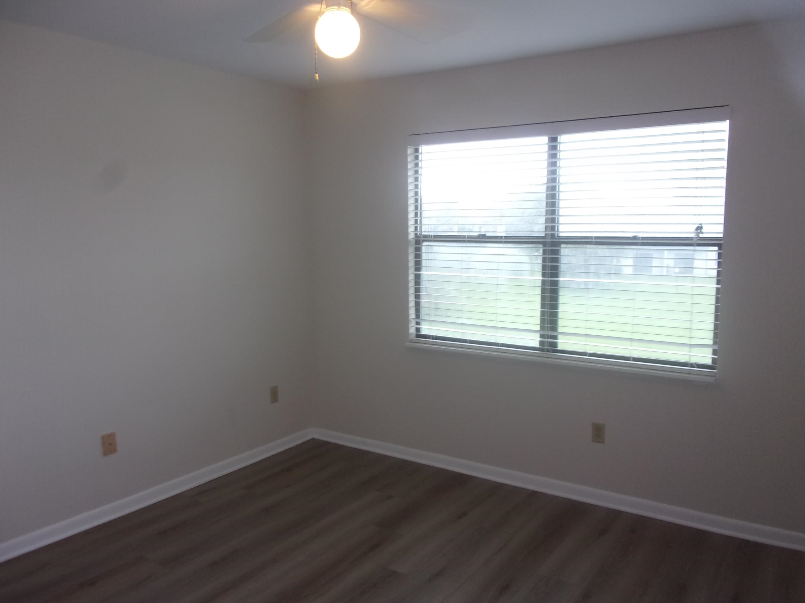 700 West Pope Road St. Augustine, FL 32080 - Photo 20 of 32 an empty room with wooden floor and windows