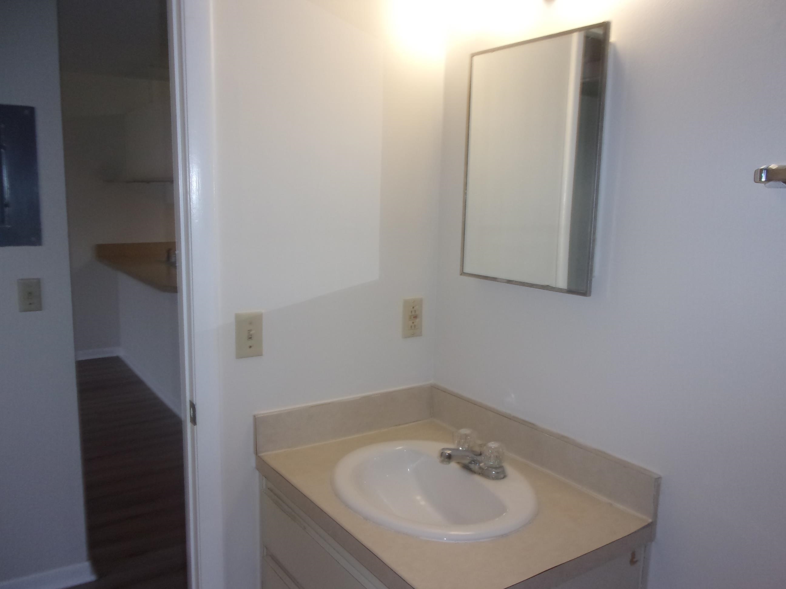 700 West Pope Road St. Augustine, FL 32080 - Photo 24 of 32 a bathroom with a sink and a mirror
