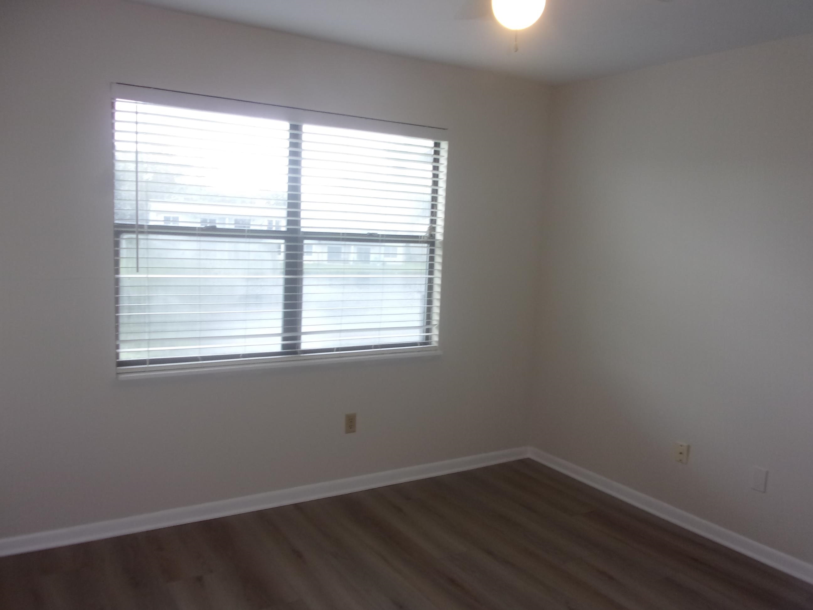 700 West Pope Road St. Augustine, FL 32080 - Photo 25 of 32 an empty room with wooden floor and windows
