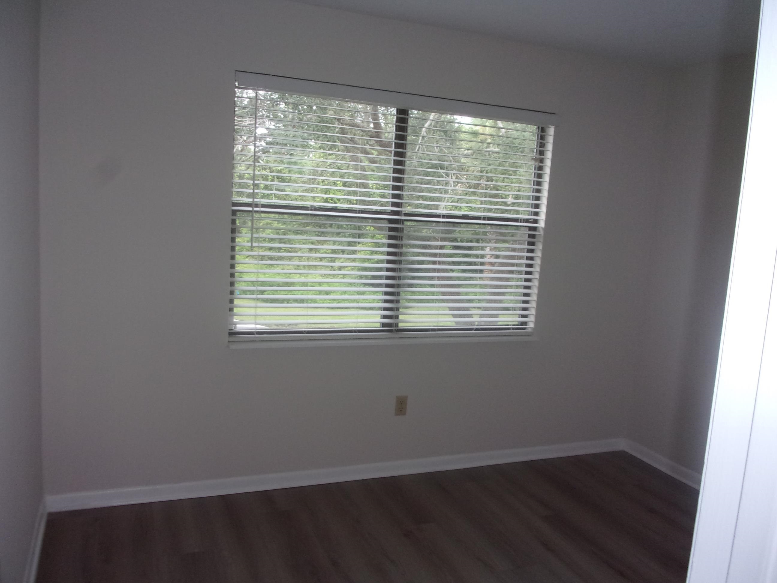 700 West Pope Road St. Augustine, FL 32080 - Photo 29 of 32 a view of an empty room with wooden floor and a window