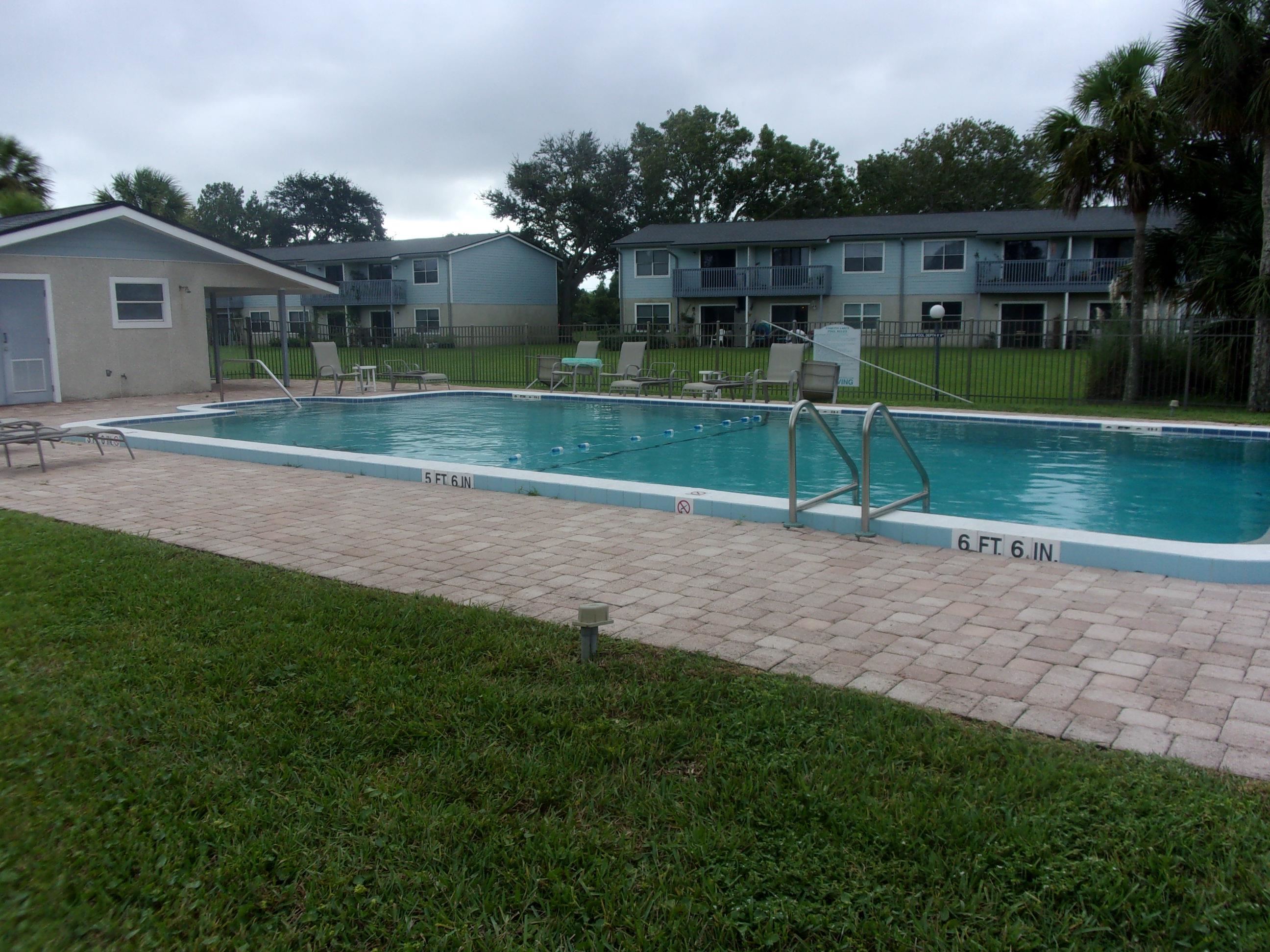 700 West Pope Road St. Augustine, FL 32080 - Photo 30 of 32 a view of a house in a big yard with plants and large trees