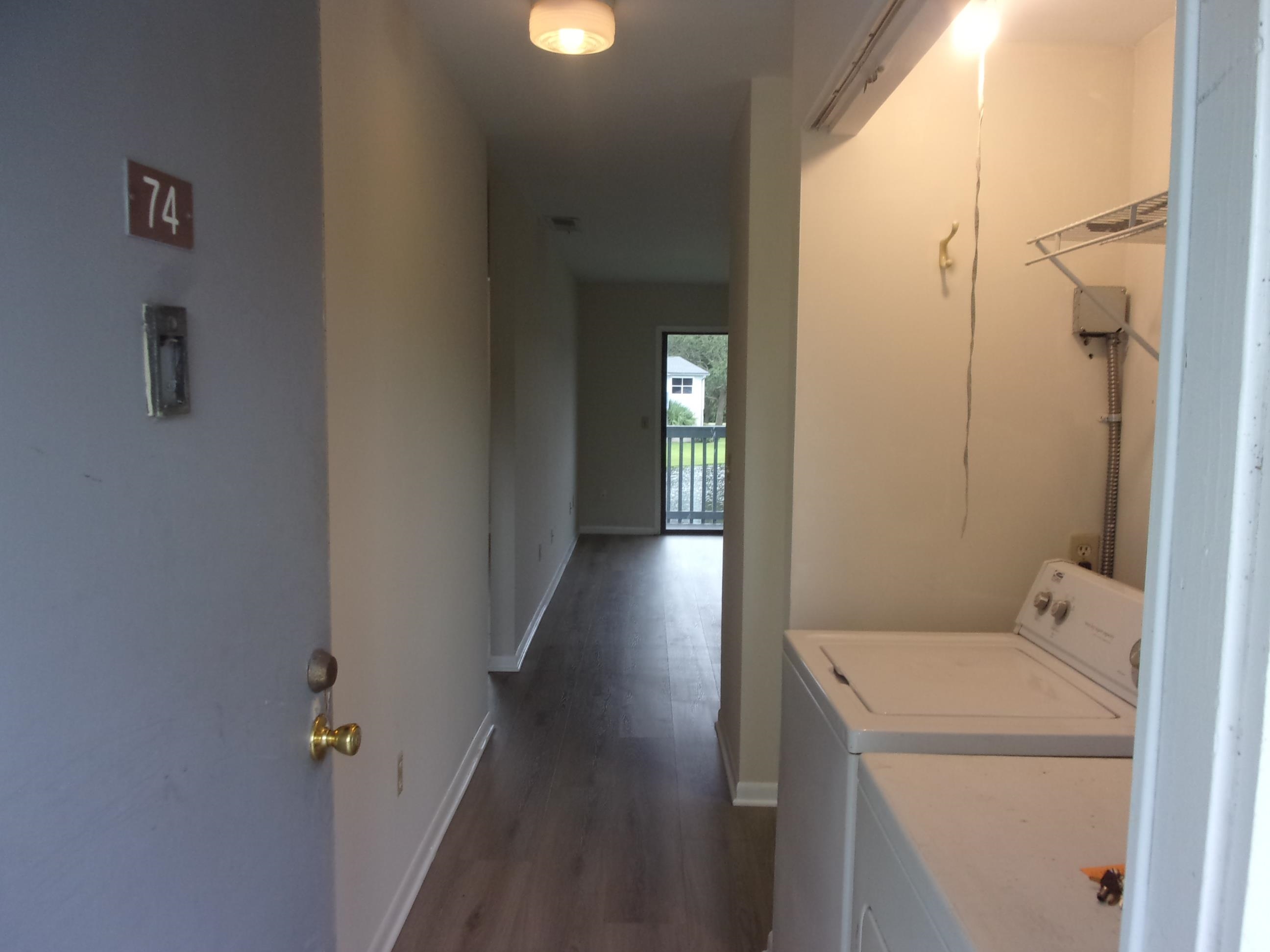 700 West Pope Road St. Augustine, FL 32080 - Photo 4 of 32 a view of a hallway with wooden floor and a bathroom
