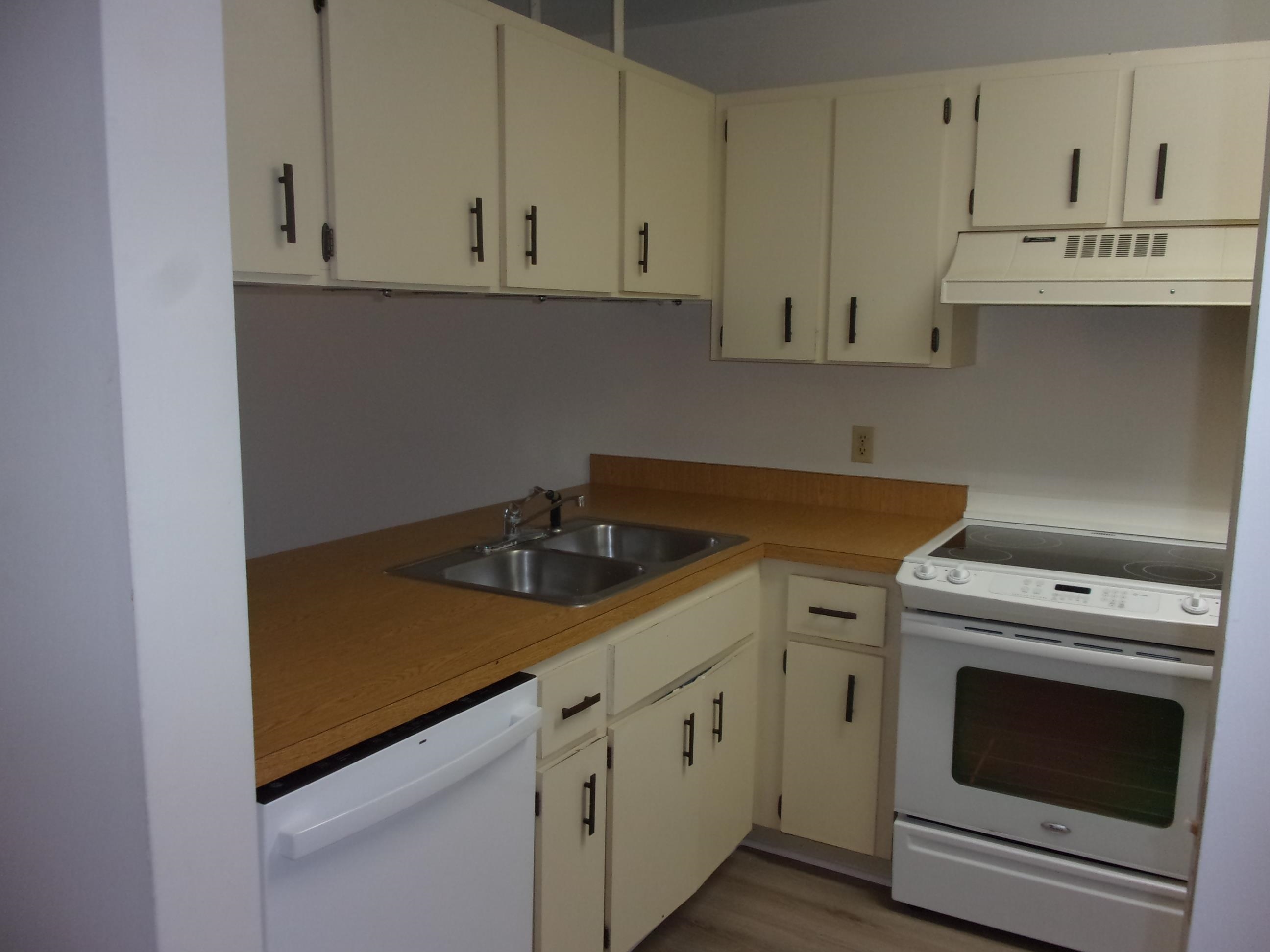 700 West Pope Road St. Augustine, FL 32080 - Photo 7 of 32 a view of a kitchen with white cabinets