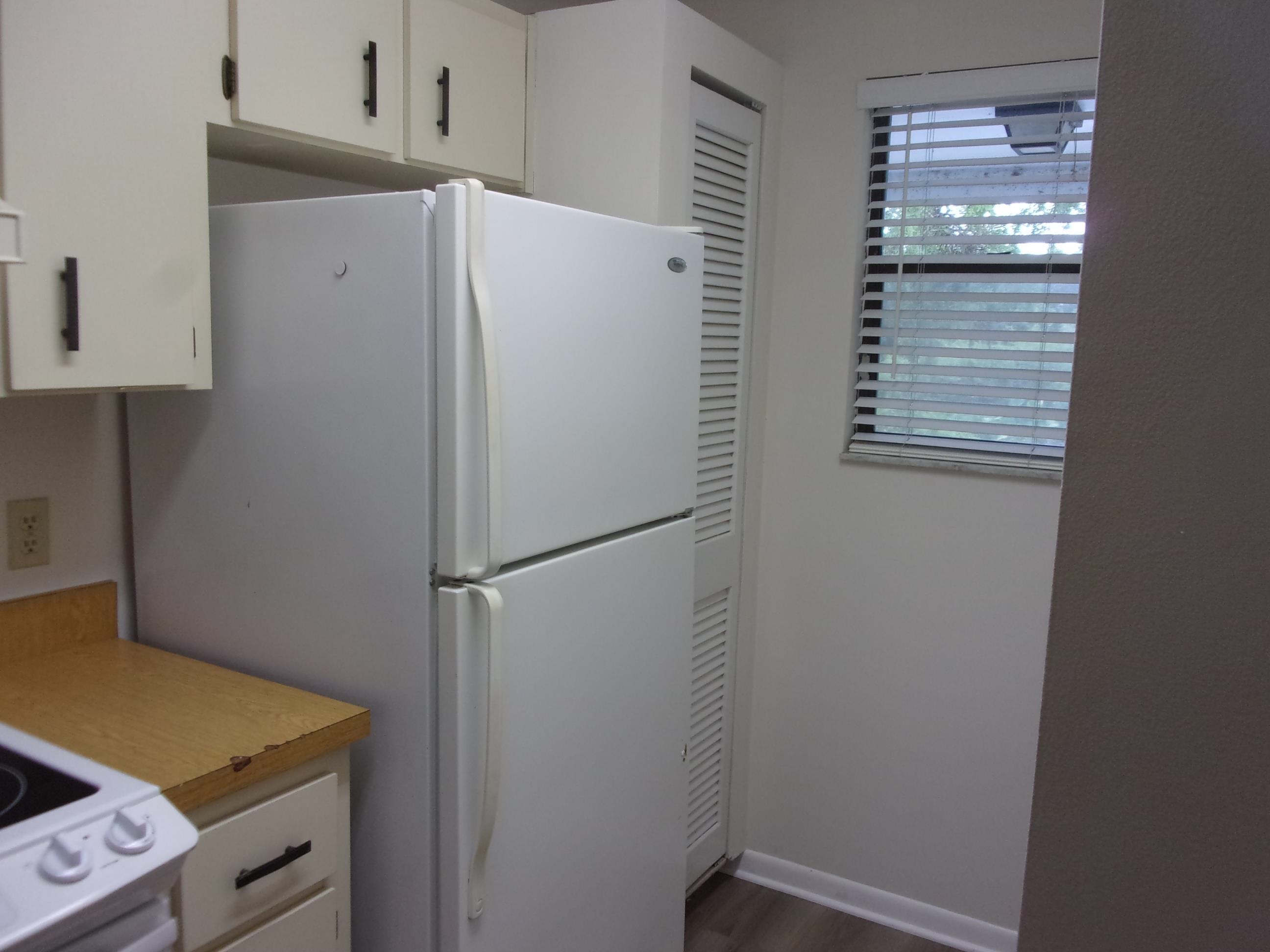 700 West Pope Road St. Augustine, FL 32080 - Photo 9 of 32 a white refrigerator freezer and a stove sitting inside of a kitchen
