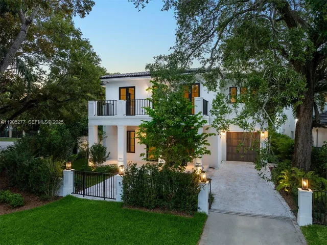 a view of a house with garden and a trees