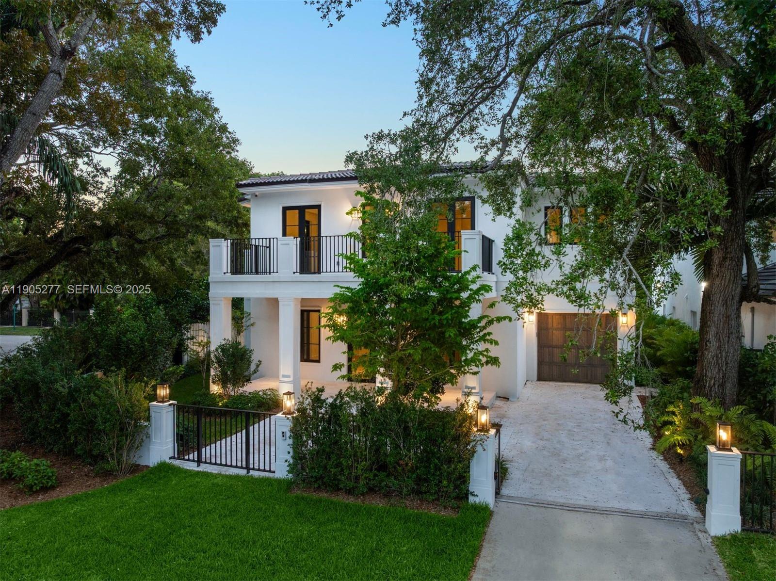 a view of a house with garden and a trees