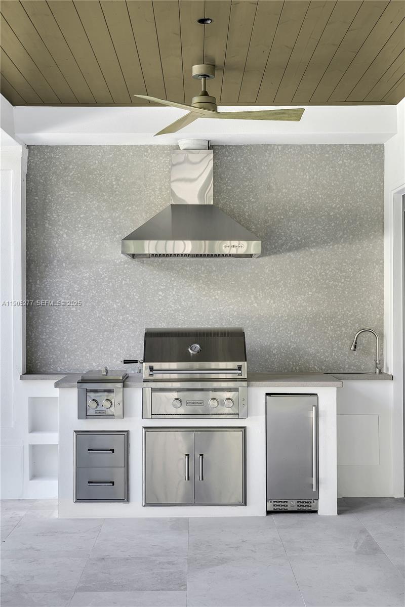 4191 Battersea Road Miami, FL 33133 - Photo 11 of 27 a stove top oven sitting inside of a kitchen