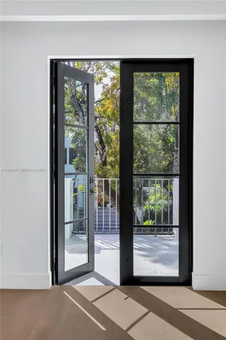 a view of staircase with railing and white walls