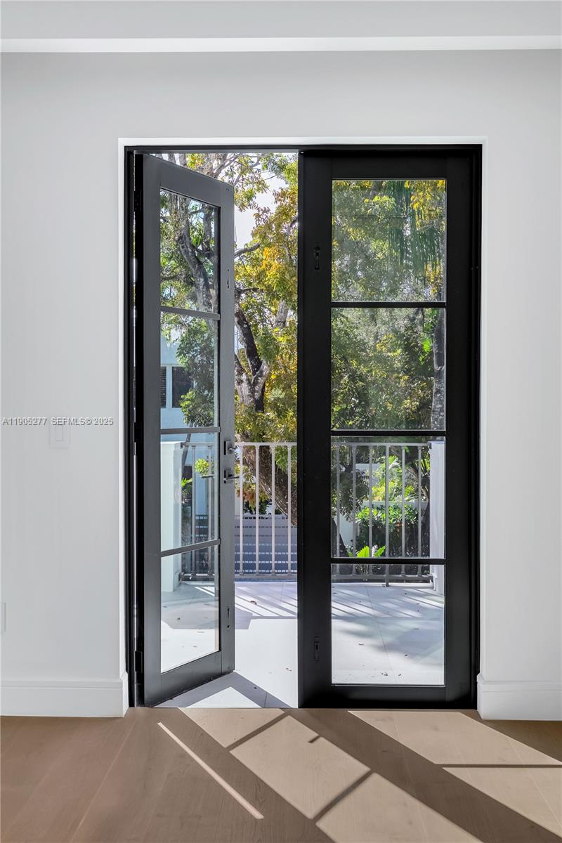 4191 Battersea Road Miami, FL 33133 - Photo 15 of 27 a view of a room that has a large window and front door