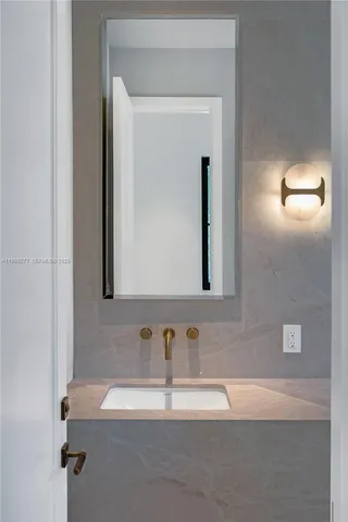 a bathroom with a mirror and a sink