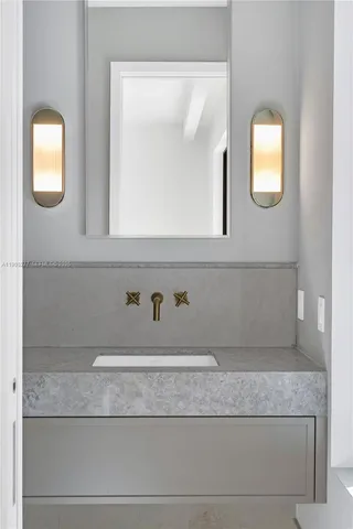 a bathroom with a sink and mirror