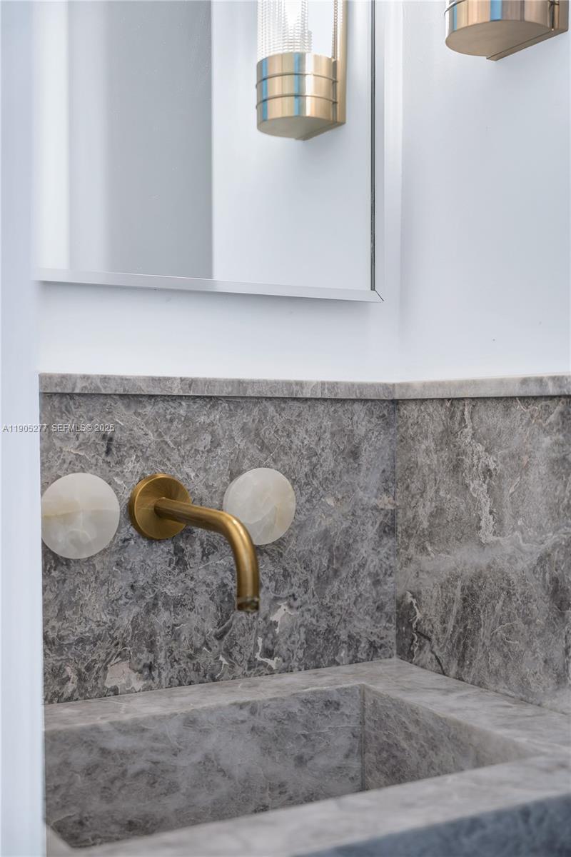 4191 Battersea Road Miami, FL 33133 - Photo 25 of 27 a bathroom with a sink and mirror