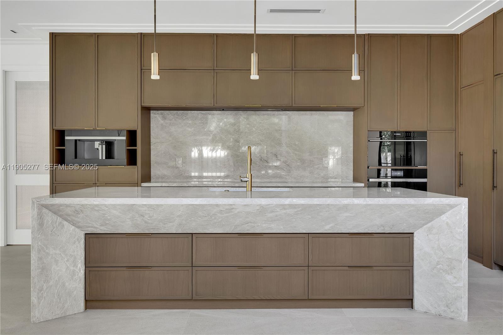 4191 Battersea Road Miami, FL 33133 - Photo 4 of 27 a kitchen with kitchen island a sink stainless steel appliances and cabinets