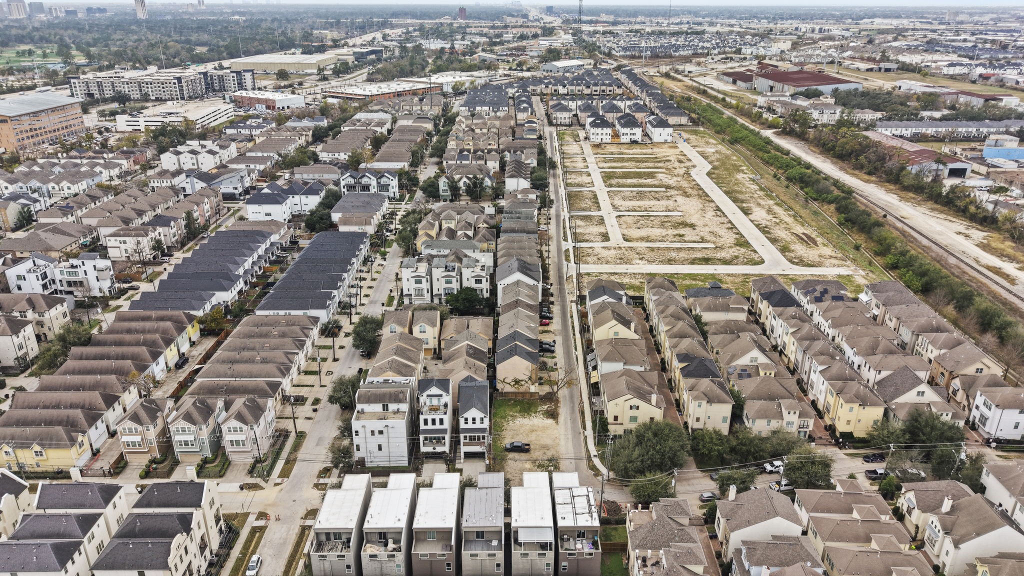 5807 Katy Street Houston, TX 77007 - Photo 20 of 37 This direct aerial view highlights the clean boundaries and strategic positioning of the lot. Flanked by luxury townhomes, this site is the missing piece in a premium residential row.