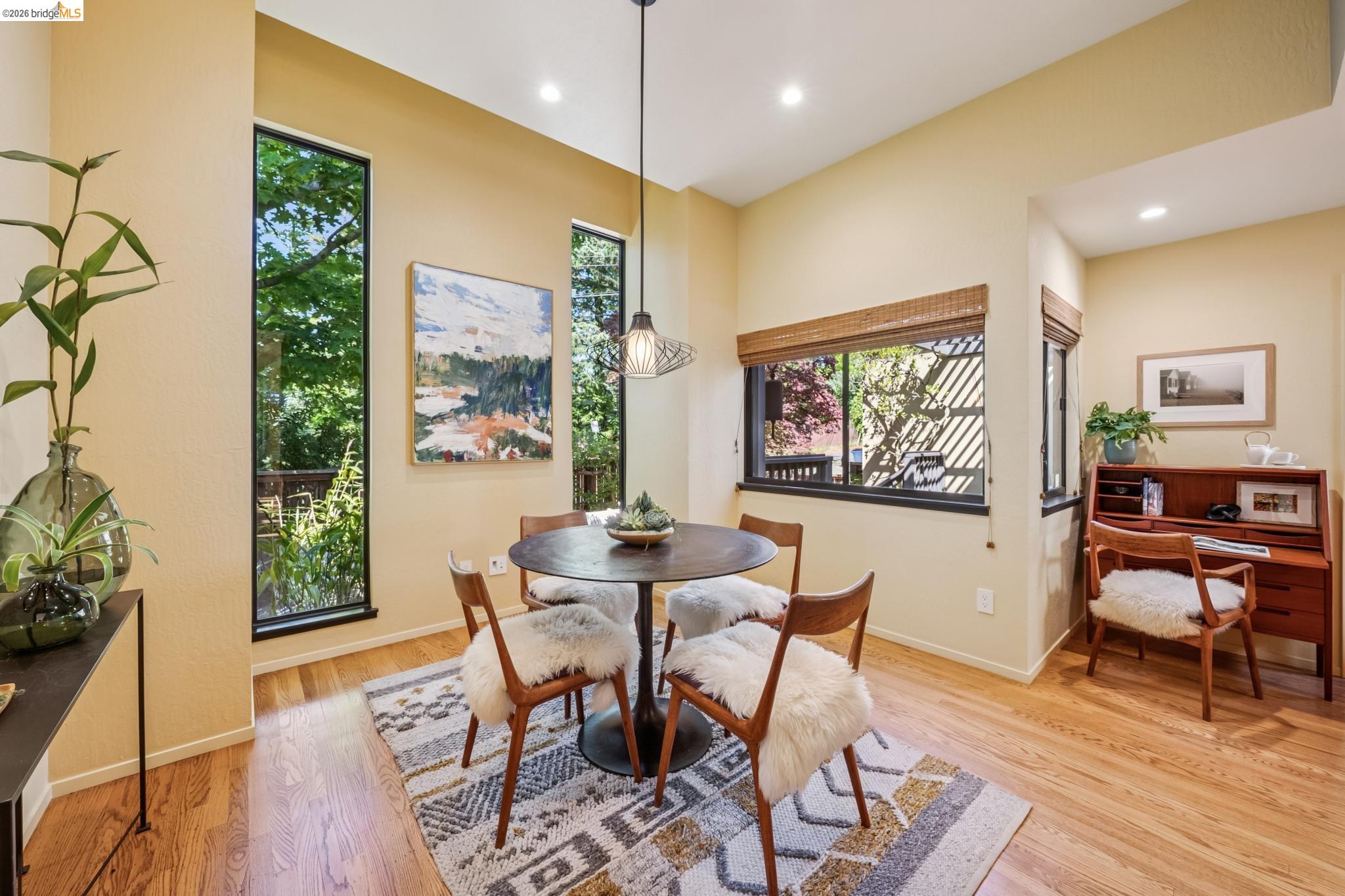 576 Vistamont Avenue Berkeley, CA 94708 - Photo 8 of 33 Breakfast area featuring high ceilings, wood-finish flooring, a contemporary pendant light fixture, recessed lighting, and multiple windows