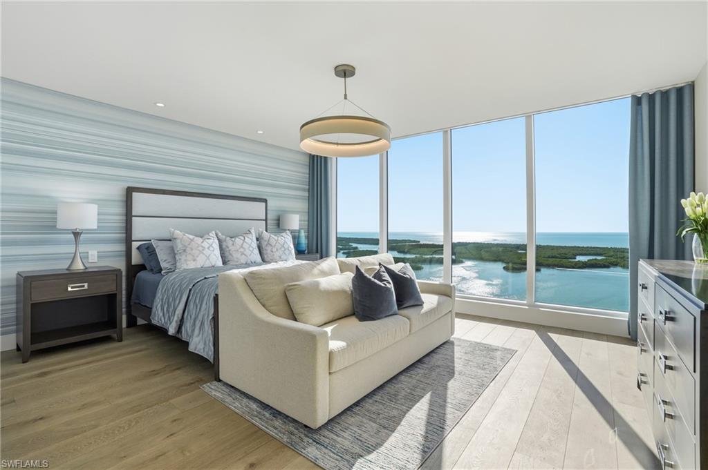 13945 Old Coast Road, Unit 1906 Naples, FL 34110 - Photo 11 of 40 a living room with furniture and a large window