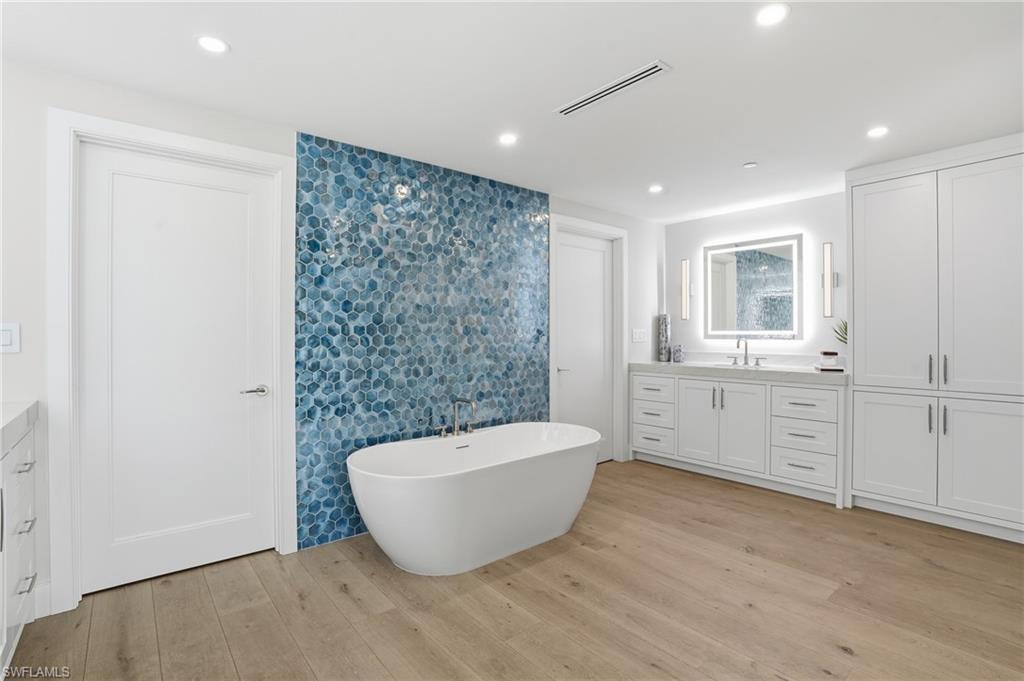 13945 Old Coast Road, Unit 1906 Naples, FL 34110 - Photo 13 of 40 a spacious bathroom with a bathtub and shower