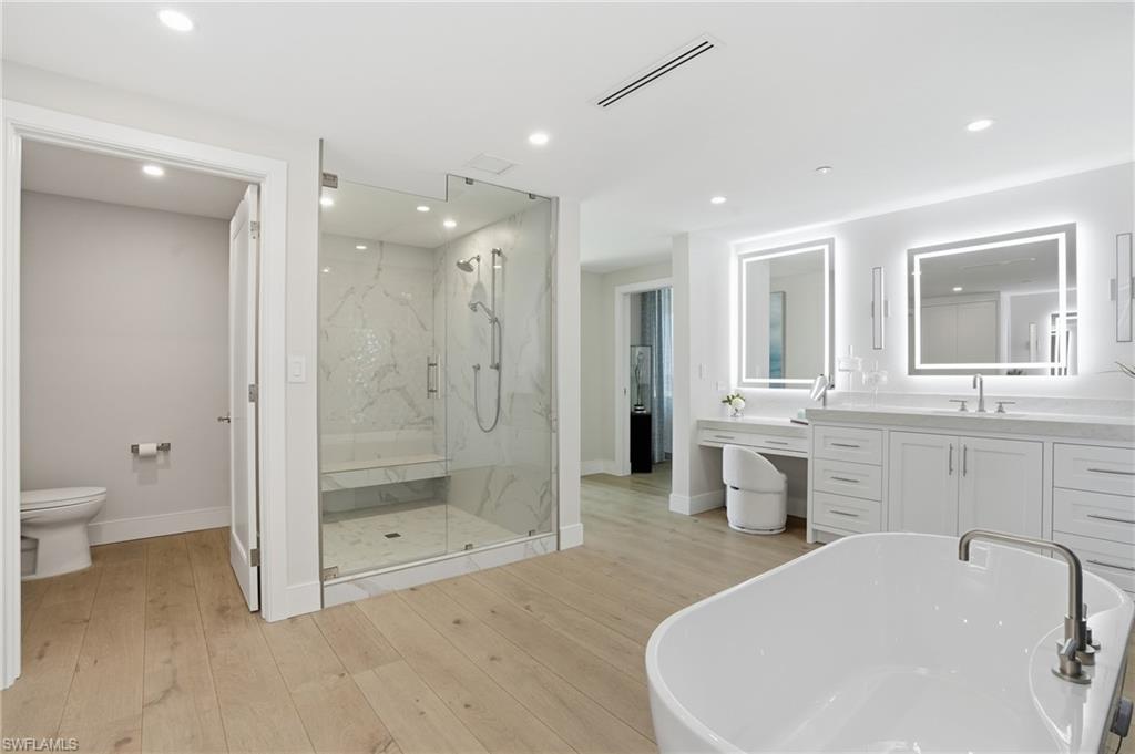 13945 Old Coast Road, Unit 1906 Naples, FL 34110 - Photo 14 of 40 a bathroom with a sink a toilet and shower