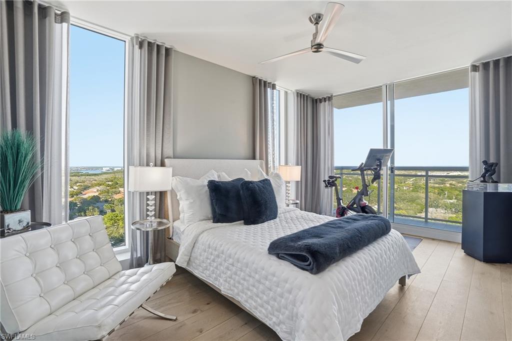13945 Old Coast Road, Unit 1906 Naples, FL 34110 - Photo 20 of 40 a bedroom with a large bed and a large window