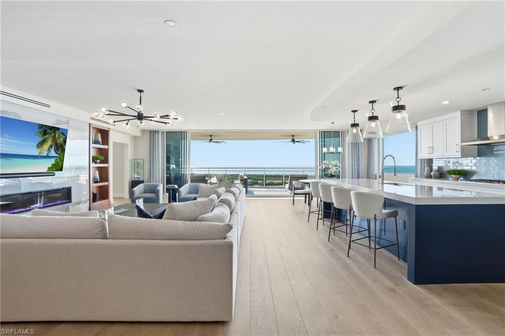 13945 Old Coast Road, Unit 1906 Naples, FL 34110 - Photo 2 of 40 a living room with furniture kitchen view and a chandelier