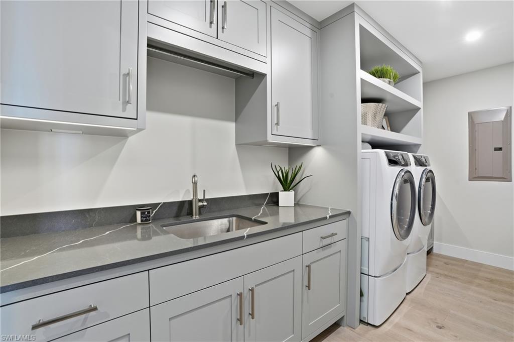 13945 Old Coast Road, Unit 1906 Naples, FL 34110 - Photo 22 of 40 a bathroom with a sink and a mirror