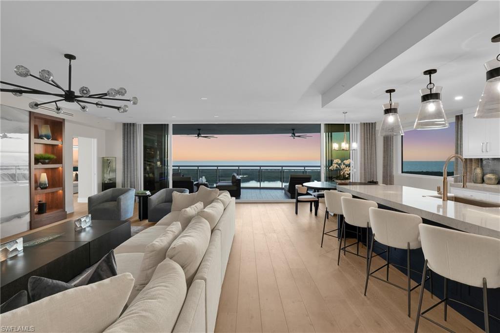 13945 Old Coast Road, Unit 1906 Naples, FL 34110 - Photo 26 of 40 a living room with furniture and a large window