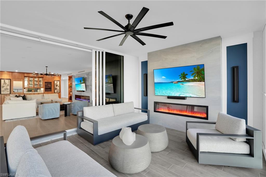 13945 Old Coast Road, Unit 1906 Naples, FL 34110 - Photo 30 of 40 a living room with furniture and a flat screen tv