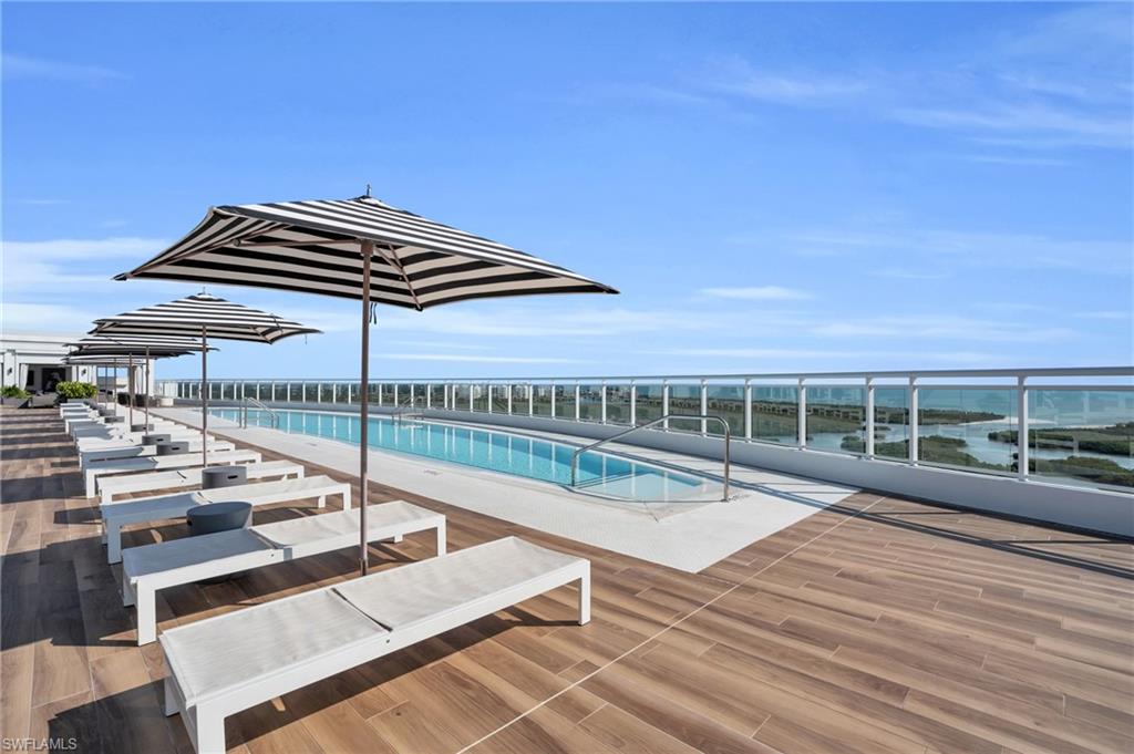 13945 Old Coast Road, Unit 1906 Naples, FL 34110 - Photo 35 of 40 a view of a roof deck with couches and wooden floor
