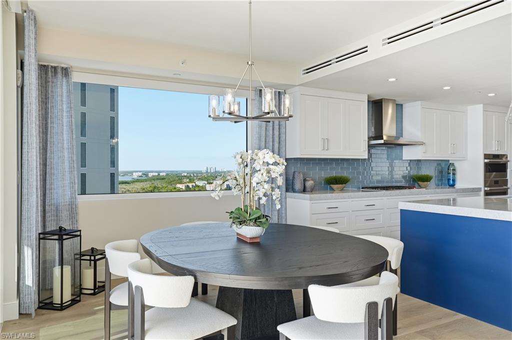 13945 Old Coast Road, Unit 1906 Naples, FL 34110 - Photo 8 of 40 a view of a dining room with furniture window and wooden floor
