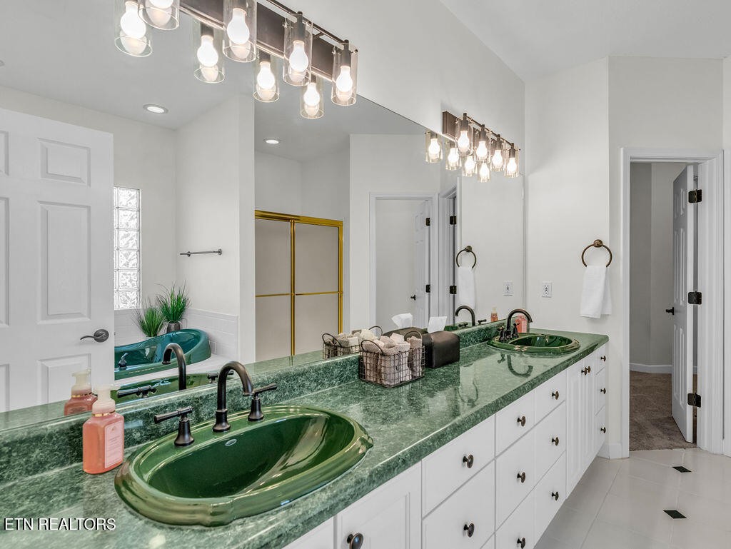 7425 Lawford Road Knoxville, TN 37919 - Photo 28 of 57 a bathroom with a granite countertop sink and a mirror