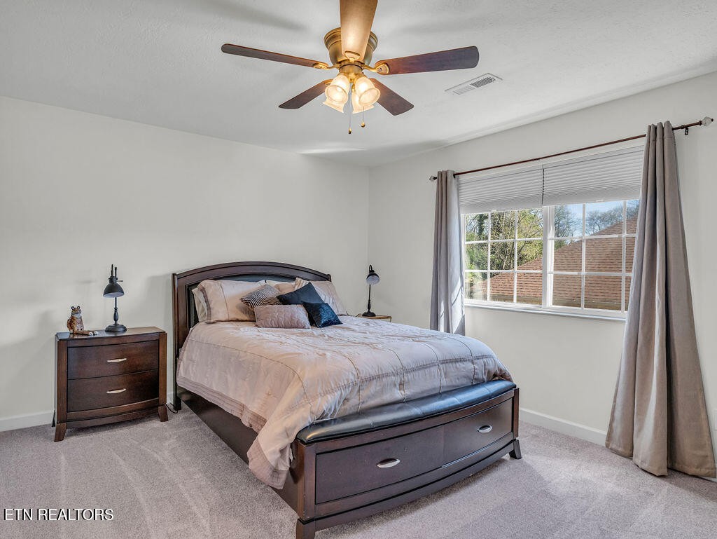 7425 Lawford Road Knoxville, TN 37919 - Photo 40 of 57 a bed sitting in a bedroom next to a window