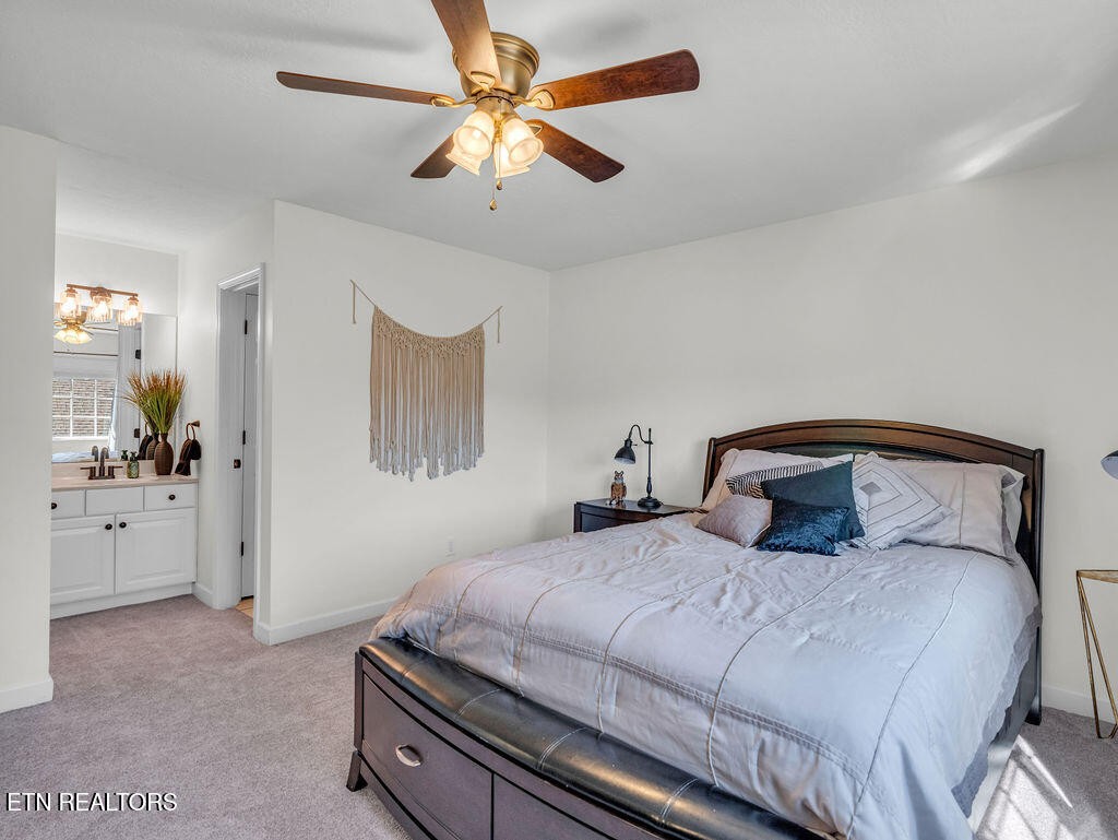 7425 Lawford Road Knoxville, TN 37919 - Photo 41 of 57 a bedroom with a bed and a chandelier