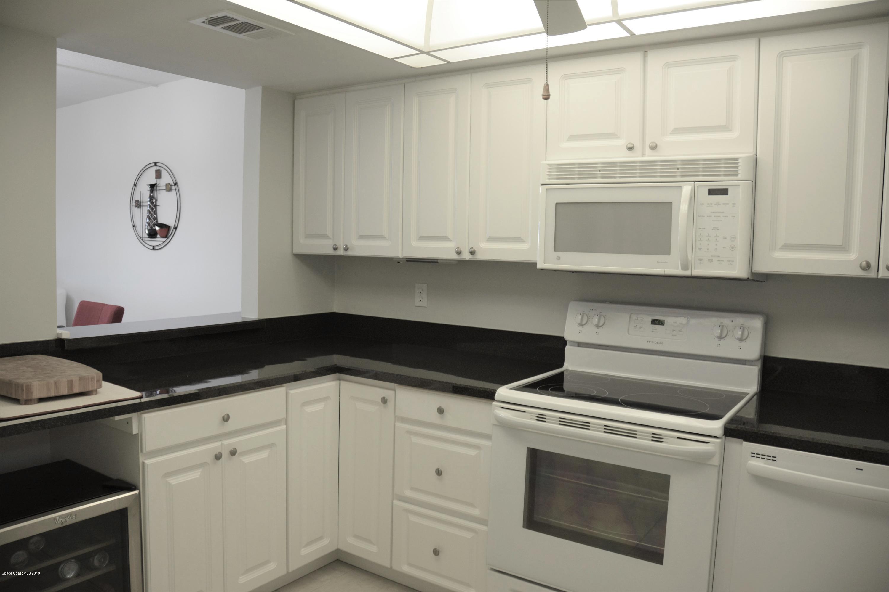 2775 North Wickham Road, Unit 404 Melbourne, FL 32935 - Photo 3 of 28 DSC_6641 - kitchen light adjusted