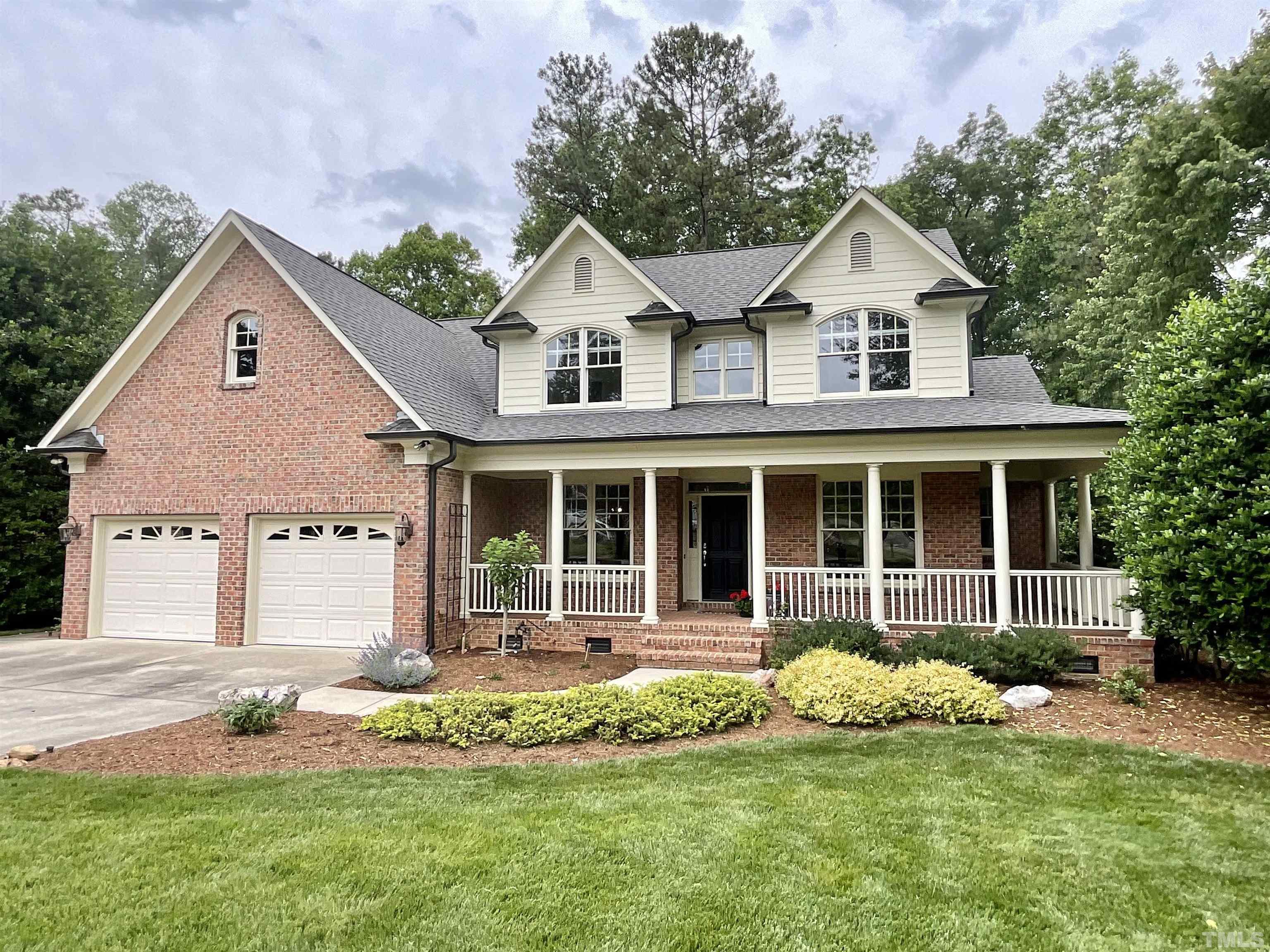 a front view of a house with a yard and porch